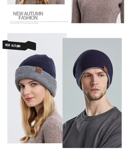 Detail showing knit texture and leather logo patch on a navy blue winter beanie