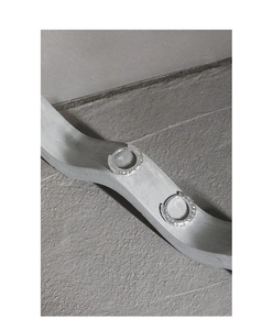 Macro detail of S925 sterling silver hoop earrings with hammered texture on stone base