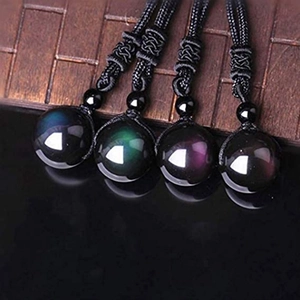 Macro detail of 16mm obsidian beads showing natural rainbow sheen and woven black cords