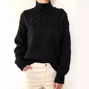Women's black cable knit turtleneck sweater with long sleeves and elegant braided texture