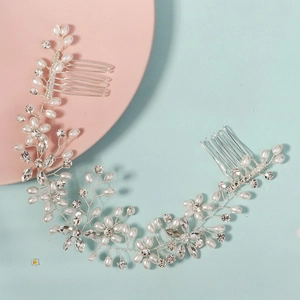 Macro shot of silver wire bridal hair accessory with white pearls and sparkling crystals