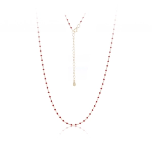 Macro shot of s925 silver necklace with delicate red beads and golden spring clasp detail