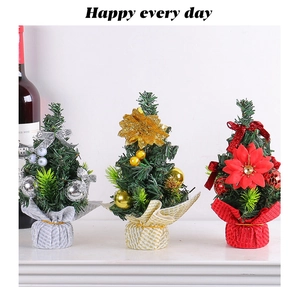 Three mini Christmas trees with silver, gold and red bases for festive table decoration