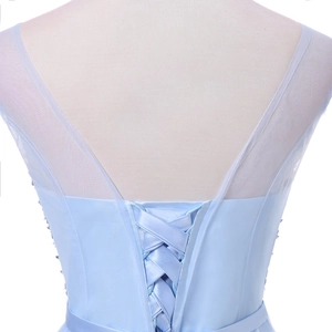 Close-up of light blue evening gown with corset lace-up back and beaded mesh detailing