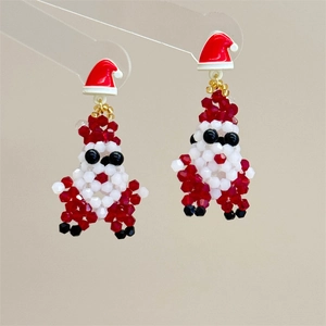 Detailed view of handcrafted beaded Santa Claus earrings with a festive red hat design