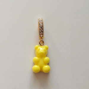 Close-up of yellow gummy bear pendant with a sparkling gold crystal-set clasp
