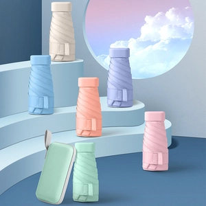 Flat mini folding sun umbrellas in six pastel colors with a portable capsule storage case