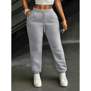 Women's minimalist grey jogger pants with drawstring waist and elastic cuffs on a model
