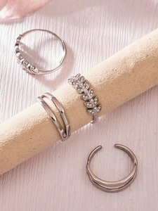 Detailed macro view of four adjustable silver rings featuring wheat leaf zircon designs