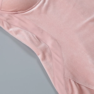Close-up of pink velvet fabric showing premium texture and fine stitching detail