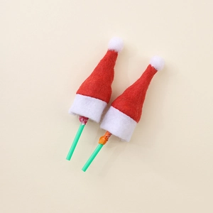 Close-up of mini red felt Christmas hats used as lollipop toppers for party decorations
