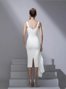 Back view of white velvet midi dress featuring a zipper closure and elegant slit detail