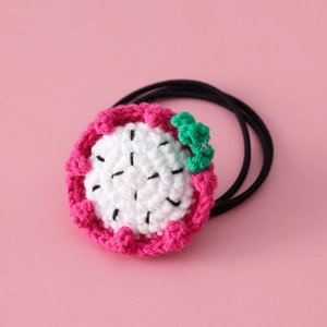 Handmade crochet pitaya hair tie for girls featuring cute fruit slice design on pink background