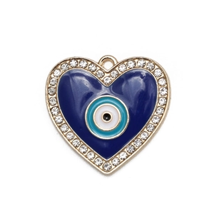 Macro detail of heart-shaped blue enamel evil eye charm with gold plating