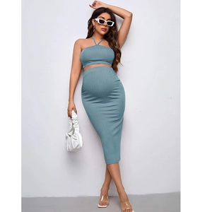 Detailed texture of grey-blue ribbed knit maternity set with halter top and midi skirt