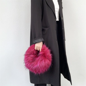 Detail of rose red faux fur doughnut bag showing fluffy texture and round handle