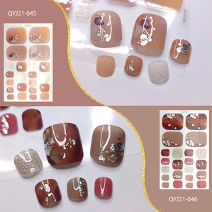 Detail view of gold foil amber and nude glitter toe nail stickers in two stylish designs