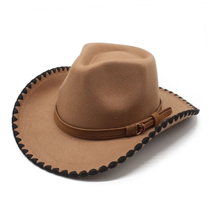 Detail of brown western cowboy felt hat with black cross-stitch edges and leather belt buckle