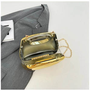 Detailed interior view of a gold metallic hard shell evening clutch with a chain strap