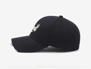 Detail of distressed brim and 3D embroidery on a black vintage cotton baseball cap