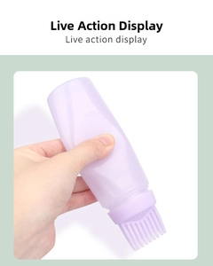 Detail view of the purple silicone squeezing bottle with clear volume scale and brush