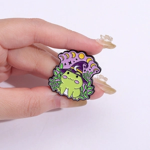 Cute Halloween wizard frog enamel pin with purple crescent moon hat and leaf accents