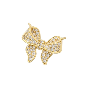 Macro shot of a gold bow pendant with sparkling clear cubic zirconia stones