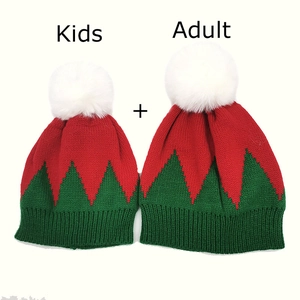 Detail of Christmas elf style knitted beanie set for adults and kids with white pom-poms