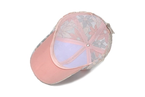 Detailed interior of women's pink lace flower baseball cap showing metal buckle and lining