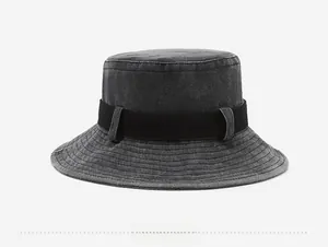 Rear view of washed dark grey cotton bucket hat with black webbing and stitch brim
