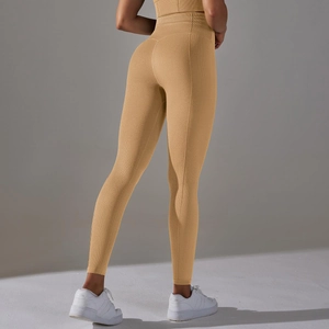 Detail of high waisted yoga leggings with unique honeycomb texture and seamless compression fit