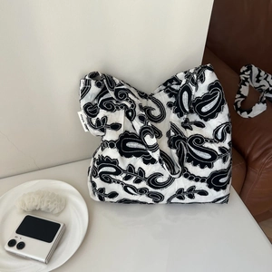 Detail of embroidered paisley pattern on the black and white cotton linen shoulder bag
