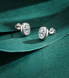 Macro shot of oval-cut zircon studs in 925 silver with visible S925 hallmark
