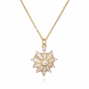 Golden heart pendant necklace with white enamel and sparkling zircon stones on white background