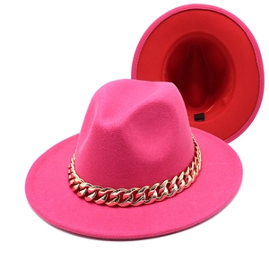 Detail of fuchsia fedora with chunky gold chain and red hat interior sweatband view