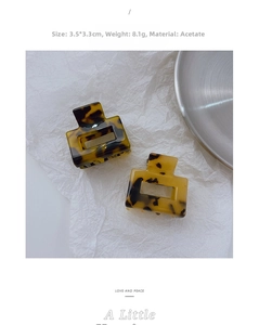Detail view of mini acetate hair claws in tortoise pattern with 3.5x3.3cm dimensions