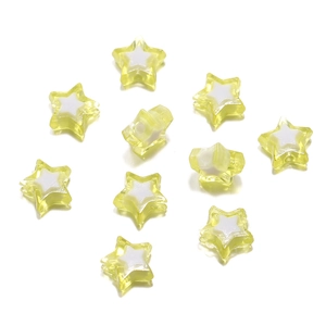 Macro shot of yellow and white acrylic star beads for DIY jewelry and phone charms