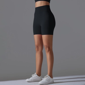 Detail view of high-waist black yoga shorts showing seamless compression and lift