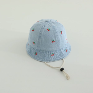 Detail of light blue denim bucket hat with cherry embroidery and adjustable windproof strap