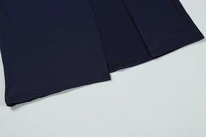 Detail of navy blue slim fit dress featuring a side slit and neat hemline stitching
