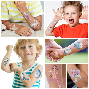 Detailed children's ocean animal temporary tattoos featuring whales and mermaids on skin
