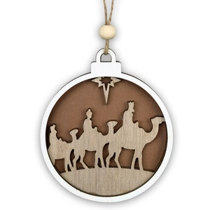 Macro detail of wooden Christmas ornament with carved Nativity scene and natural texture