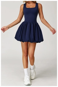 Detail shot of navy blue sleeveless tennis dress with stylish balloon skirt design