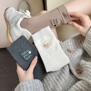 Detail of cotton crew socks with 'Follow your heart' embroidery and heart patterns
