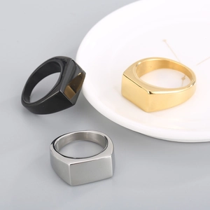 Detailed view of polished geometric signet rings in black, gold, and silver finishes
