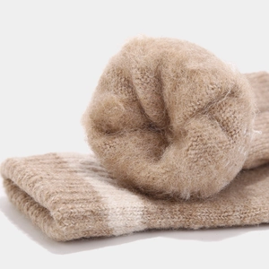 Close-up of thick winter knit socks featuring soft fleece lining and white stripe trim