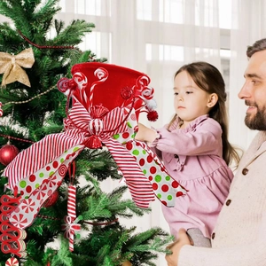 Festive red and white striped Christmas tree topper bow with candy and pompom accents