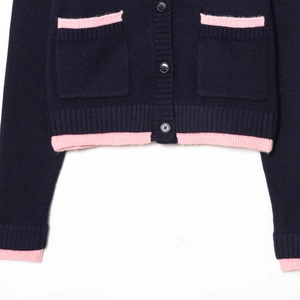 Navy blue knit cardigan with pink ribbed trim and decorative buttons for a chic look