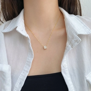 Detail of S925 silver necklace with square-cut zircon pendant on model's neckline
