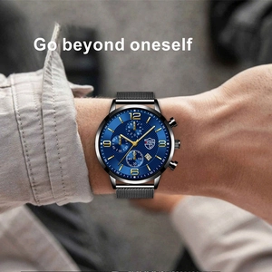 Detail of blue dial quartz watch with luminous hands and black mesh stainless steel band